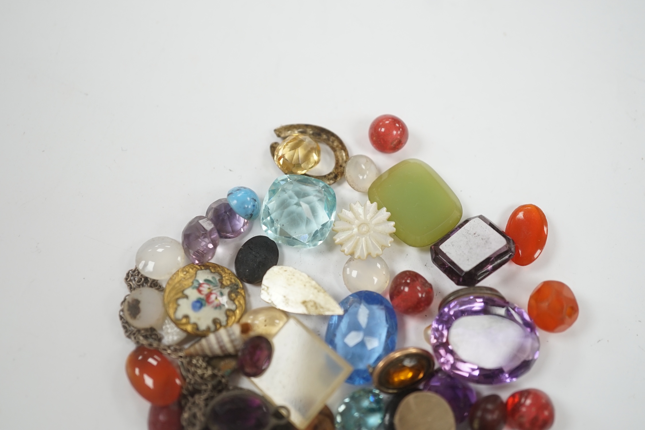 A small quantity of loose cut and cabochon gemstones including carnelian, white opal etc.